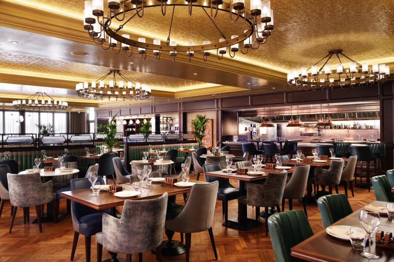 Tables, chairs and the bar inside The Rise Restaurant at The Grand, York on Station Rise