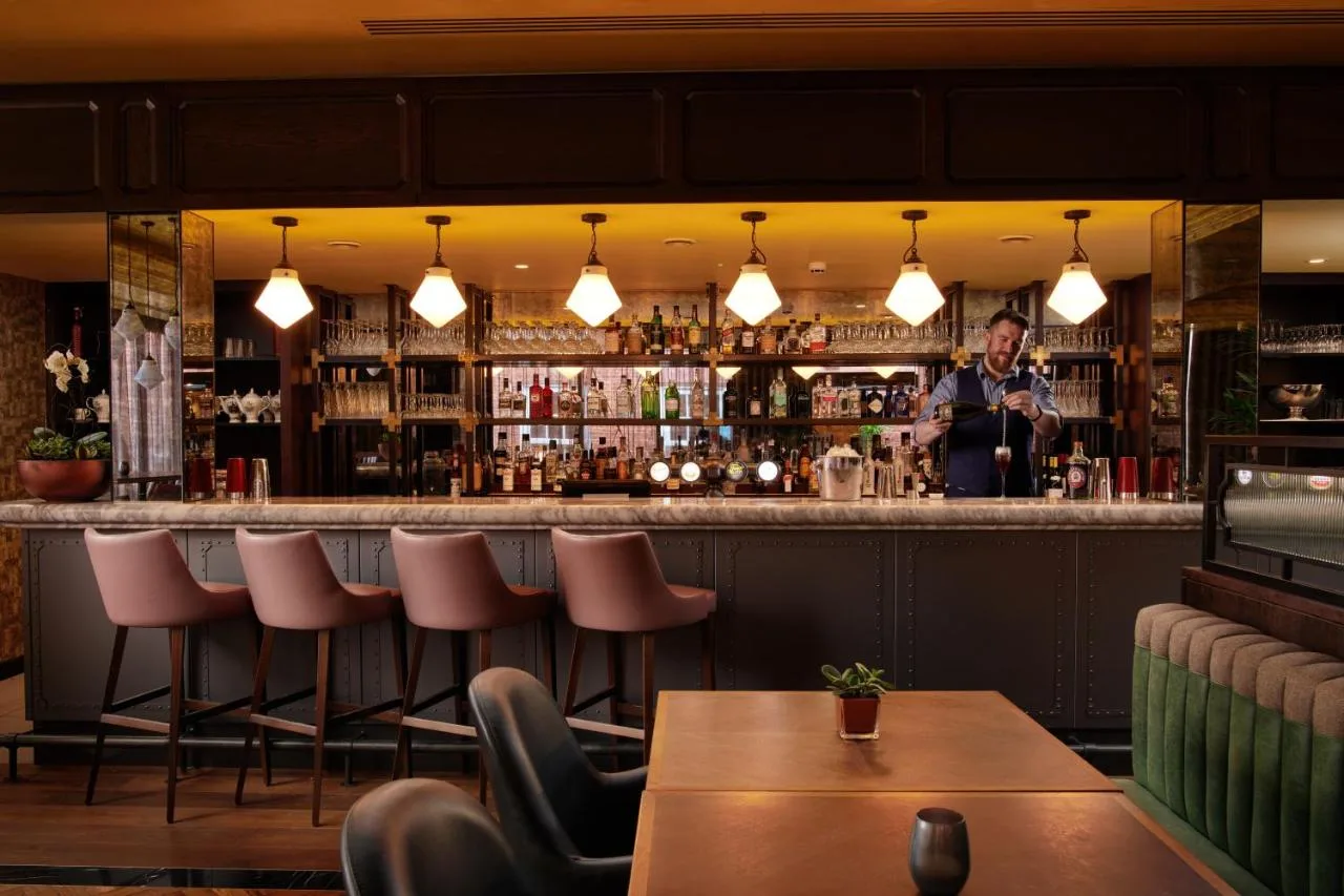 A member of staff behind the bar at The Grand, York